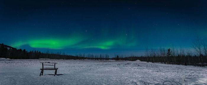 Scenic view of snowy landscape against sky at night