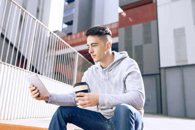Full length of man using mobile phone