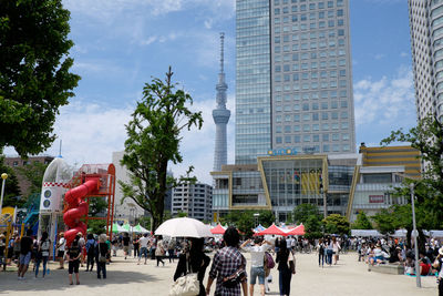 People in city against sky