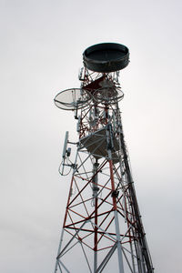 Low angle view of communications tower against sky