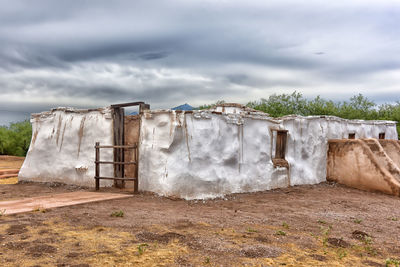 Built structure on field against sky