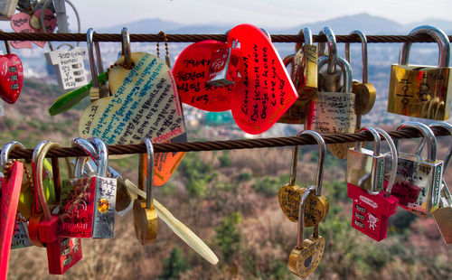 Close-up of padlocks hanging on railing