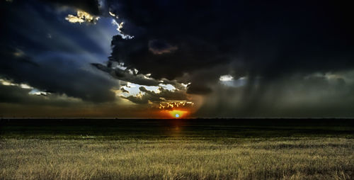 Storm clouds over field at night