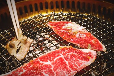 High angle view of meat on barbecue grill