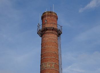 Low angle view of smoke stack against sky