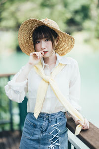 Young woman wearing hat standing outdoors