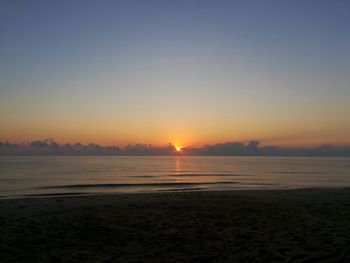 Scenic view of sea against clear sky during sunset