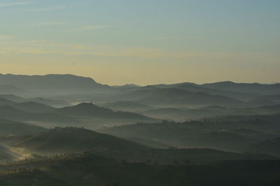 Scenic view of silhouette mountains against sky during sunset