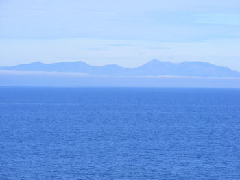 Scenic view of calm sea against cloudy sky