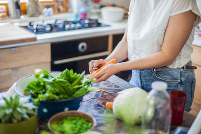 Woman preparing food on cutting board at home