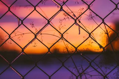 Scenic view of sea seen through chainlink fence
