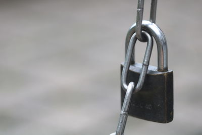 Close-up of padlock on metal chain