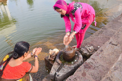 High angle view of woman standing by lake