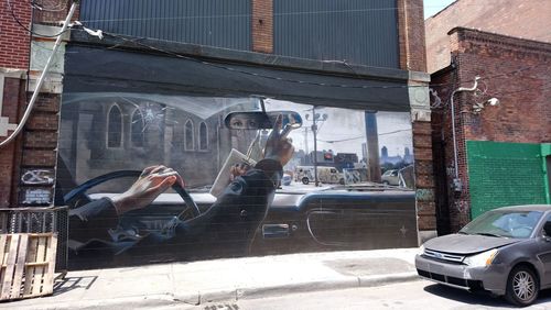 Man on street against buildings in city