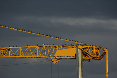 Low angle view of yellow bridge against sky