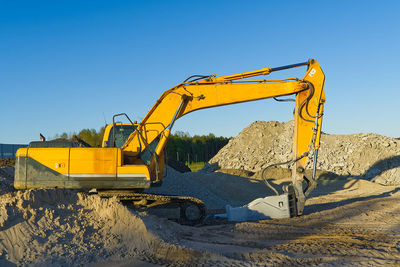 Crane at construction site against clear sky