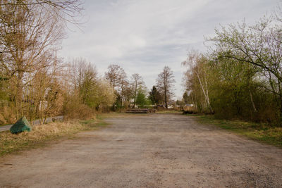 Road amidst trees against sky