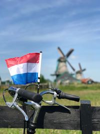 Close-up of bicycle with holland flag and windmills