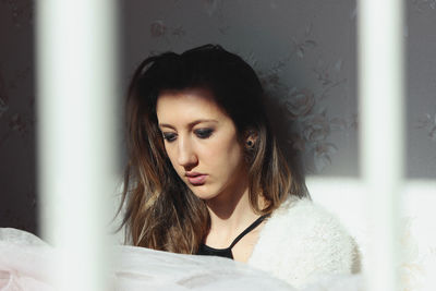 Close-up of young woman sitting at home