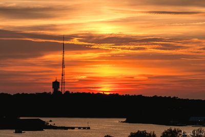 Silhouette buildings against sky during sunset