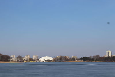 Buildings in city against clear sky