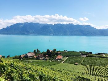 Scenic view of sea and mountains against sky