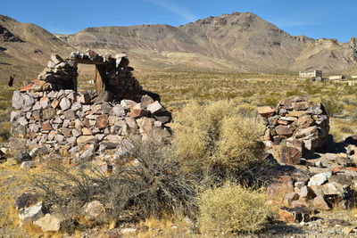 Ruins of stone house in ghost town in nevada desert landscape