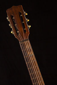 Low angle view of guitar against black background