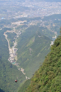 View from top of tienmen mountain, see small cable cars and geat view of nature and zhangjiajie city