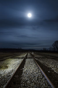 View of railroad tracks against night sky