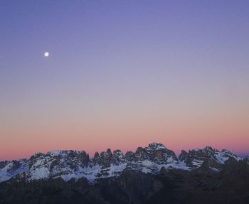 Scenic view of mountains against clear sky at sunset