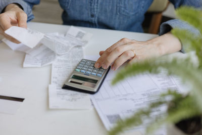 Midsection of businessman working on table