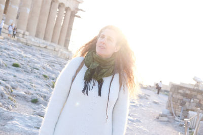 Tilt image of mature woman standing on land during sunset