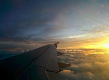 Airplane flying over landscape against sky