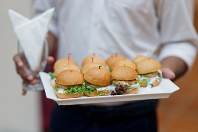 Close-up of man holding food in plate