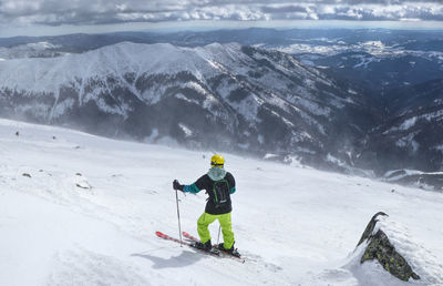 Man skiing on snowcapped mountain