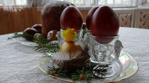 Close-up of easter eggs in eggcups on table