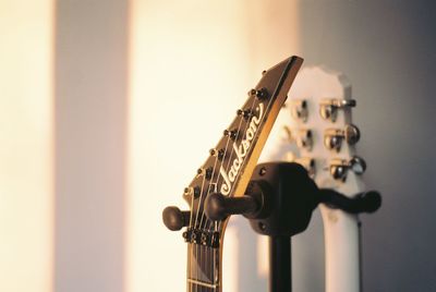 Close-up of guitar against wall