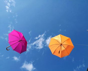 Low angle view of multi colored umbrella against sky