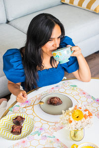 Close-up of girl playing with teddy bear on bed at home
