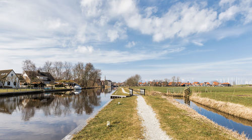 River amidst field against sky