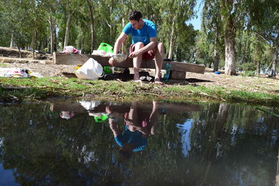 Rear view of woman sitting on bench