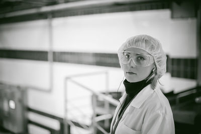 Portrait of female doctor wearing protective eyewear while working at hospital