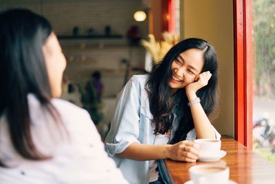 Young woman with coffee in cafe