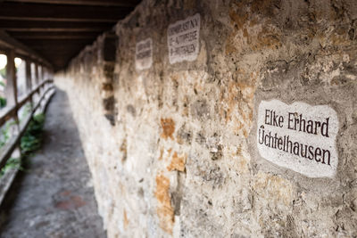 Close-up of text on brick wall