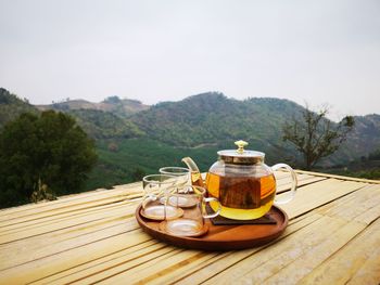 Tea cup on table against sky