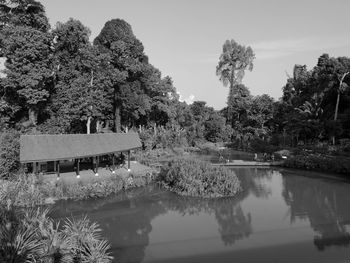 Swimming pool by lake against sky