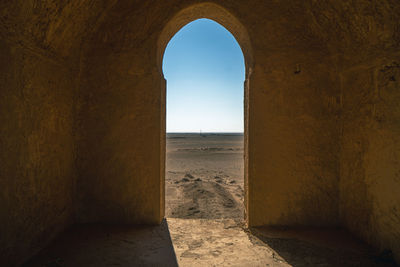 Scenic view of desert seen through historic building