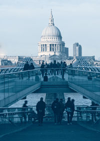 People in front of building against sky