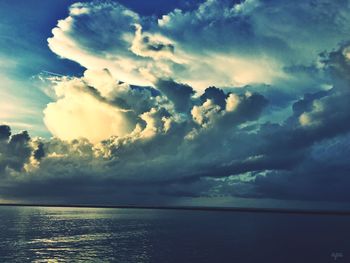 Scenic shot of calm sea against cloudy sky